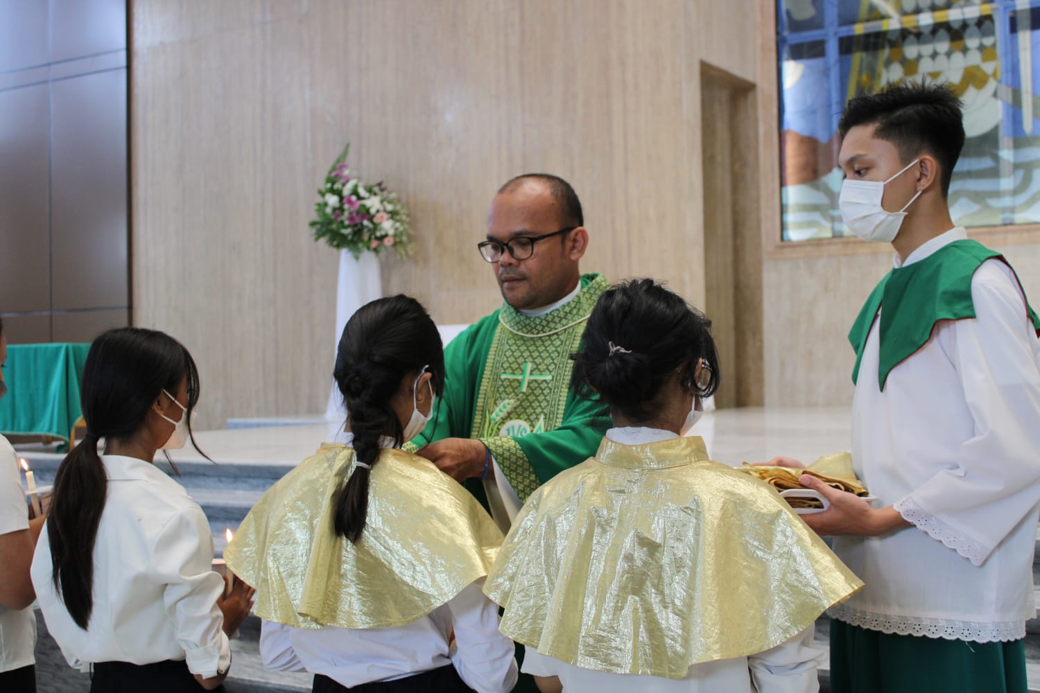 Romo Lam menandai anak misdinar yg dilantik dengan memakaikan mozeta kpd perwakilan misdinar dilantik